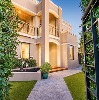 A modern two-story house with a beige exterior