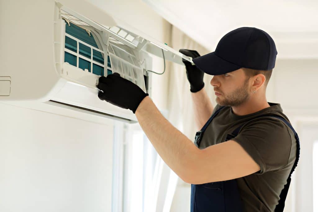 guy cleaning air conditioner